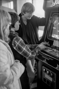 Teenagers Playing Video Game Machine
